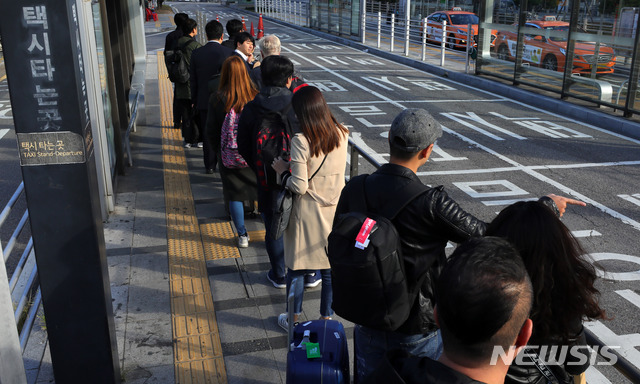 【서울=뉴시스】배훈식 기자 = 카카오의 카풀 서비스에 반발해 택시업계가 파업에 돌입한 18일 오전 서울 용산구 서울역 앞 택시승강장에 시민들이 길게 줄을 서고 있다. 2018.10.18.&nbsp; dahora83@newsis.com