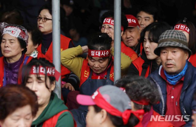 【서울=뉴시스】조성봉 기자 = 노량진수산시장 구 시장에 대한 명도 강제집행이 예정된 23일 오전 서울 영등포구 노량진수산시장 구 시장 앞에서 상인들이 '절대사수' 라고 적힌 머리띠를 묶고 있다.&nbsp; 2018.10.23.suncho21@newsis.com