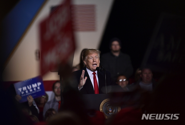 President Donald Trump speaks during a rally at Central Wisconsin Airport in Mosinee, Wis., Wednesday, Oct. 24, 2018. (AP Photo/Susan Walsh)