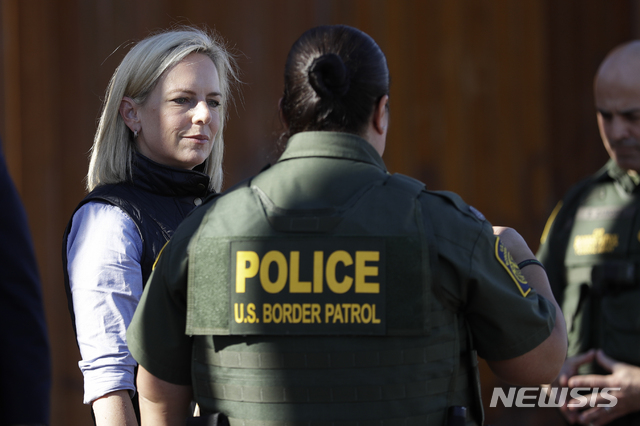 U.S. Department of Homeland Security Secretary Kirstjen Nielsen, left, speaks with Border Patrol agents near a newly fortified border wall structure Friday, Oct. 26, 2018, in Calexico, Calif. (AP Photo/Gregory Bull)