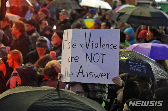 【피츠버그=AP/뉴시스】 미국 펜실베니아주 피츠버그의 스쿼럴 힐에 있는 유대교 예배당에서 27일(현지시간) 총기 난사 사건이 발생해 최소 11명이 숨지고 6명이 중상을 입었다. 사진은 사건이 일어난 예배당 인근에서 열린 추모 집회에 참석한 한 시민이 "증오와 폭력은 답이 아니다"라고 쓴 손팻말을 들어올리고 있는 모습. 이번 사건의 범인은 로버트 바우어스란 40대 남성으로, 범행 직전 "유대인 다 죽어라"라고 외친 것으로 알려졌다. 2018.10.28 