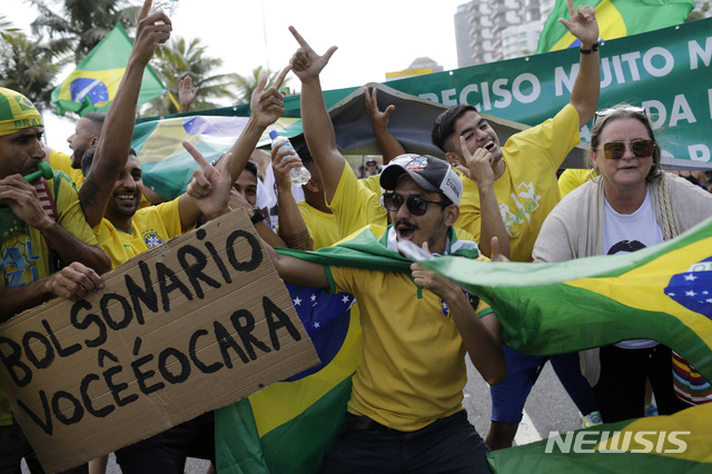 【리우데자네이루( 브라질) = AP/뉴시스】 브라질의 우파 대선후보 자이르 보우소나루의 지지자들이&nbsp; 28일 결선투표장 밖에 모여서 그의 이름을 연호하고 있다.&nbsp; 선거운동기간 동안 두 파로 갈린 브라질 국민의 폭력과 갈등의 치열함에 비해 이 날 선거는 조용하고 순탄하게 치러졌다.&nbsp;&nbsp;&nbsp; 