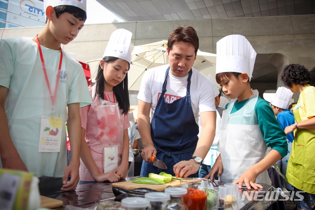 【서울=뉴시스】 서울시 친환경급식 홍보대사 샘킴 요리사는 지난해 서울시 학교·공공급식 한마당에 참가해 아이들에게 요리법을 가르쳤다.(사진= 서울시 제공) photo@newsis.com