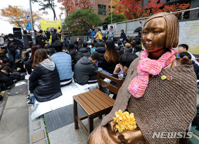 【서울=뉴시스】 = 지난해 11월 서울 종로구 주한일본대사관 앞에서 열린 일본군 위안부 피해자 문제 해결 촉구 수요집회에서 참가자들이 마이크 혼다 전 미 하원의원의 발언을 경청하고 있다. 2018.11.07. (뉴시스DB) photo@newsis.com