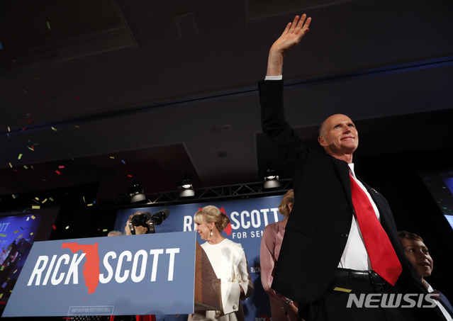 【플로리다=AP/뉴시스】 미 중간선거에서 플로리다주 상원 공화당 후보로 나선 릭 스콧이 7일(현지시간) 승리선언 후 지지자들에게 손을 흔들고 있다. 