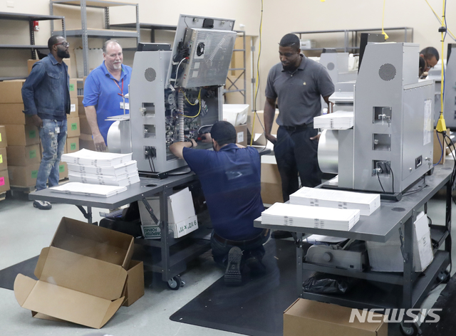  【로더힐(미 플로리다주)=AP/뉴시스】미 플로리다주 로더힐의 선거감시위원회에서 12일(현지시간) 직원들이 재검표를 위해 투표기를 검사하고 있다. 브로워드 카운티 순회법원의 판사는 공화당의 부정 행위 주장에 "자제가 필요하다"고 당부했다. 2018.11.13 