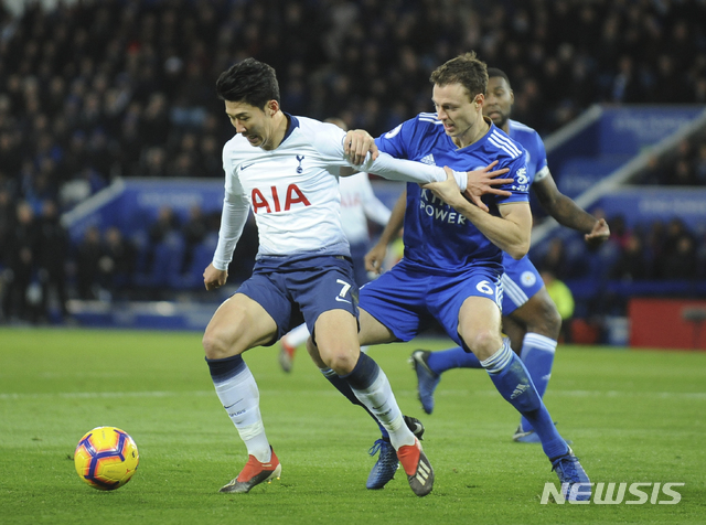 Tottenham's Heung-Min Son, left, challenge for the ball with Leicester's Jonny Evans during the English Premier League soccer match between Leicester City and Tottenham Hotspur at the King Power Stadium in Leicester, England, Saturday, Dec. 8, 2018. (AP Photo/Rui Vieira)