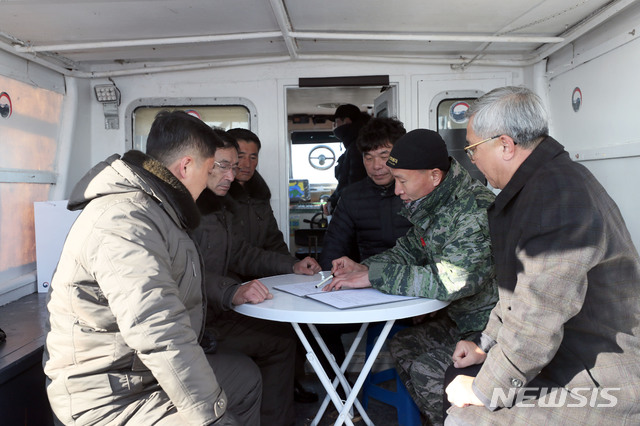 【서울=뉴시스】조성봉 기자 = 9일 한강하구 공동수로조사 종료행사에 참석한 우리측 단장 윤창희 해병 대령이 우리측 조사선에 승선한 북측 조사단장 오명철 대좌에게 수로조사결과를 설명하고 있다.2018.12.09. (사진=국방부 제공)photo@newsis.com