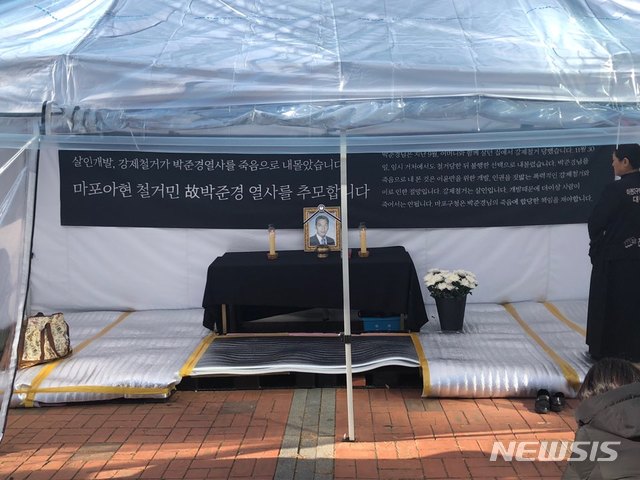 【서울=뉴시스】조인우 기자 = 마포구청앞에 설치된 박준경씨의 분향소. 재개발 지역인 아현2구역에 살던 박씨는 지난 3일 한강변에 투신해 이튿날인 4일 양화대교와 성산대교 사이에서 숨진 채 발견됐다. 2018.12.12