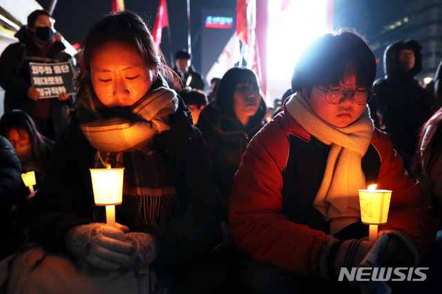 【서울=뉴시스】김병문 수습기자 = 15일 오후 서울 종로구 광화문 광장에서 열린 '태안화력발전 24살 비정규직 고 김용균씨 촛불추모제'에 참석한 시민들이 묵념을 하고 있다. 2018.12.15. dadazon@newsis.com