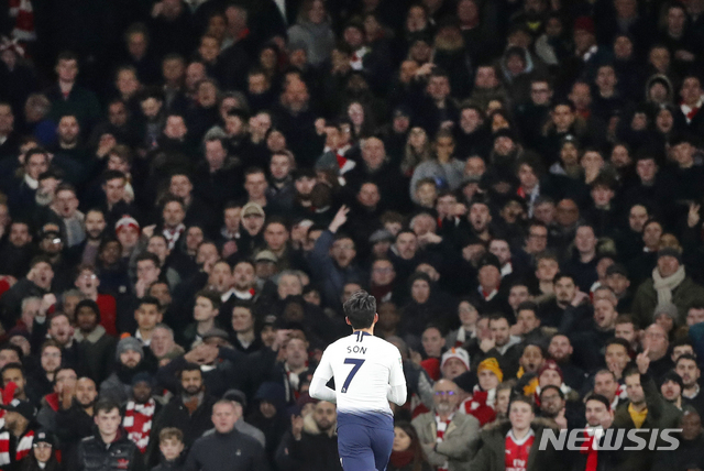 Tottenham's Son Heung-min celebrates after scoring his side's first goal during the English League Cup quarter final soccer match between Arsenal and Tottenham Hotspur at the Emirates stadium in London, Wednesday, Dec. 19, 2018. (AP Photo/Frank Augstein)