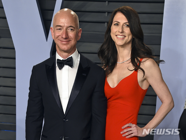 FILE - In this March 4, 2018 file photo, Jeff Bezos and wife MacKenzie Bezos arrive at the Vanity Fair Oscar Party in Beverly Hills, Calif.&nbsp; Bezos says he and his wife, MacKenzie, have decided to divorce after 25 years of marriage. Bezos, one of the world’s richest men, made the announcement on Twitter Wednesday, Jan. 9, 2019. (Photo by Evan Agostini/Invision/AP, File)