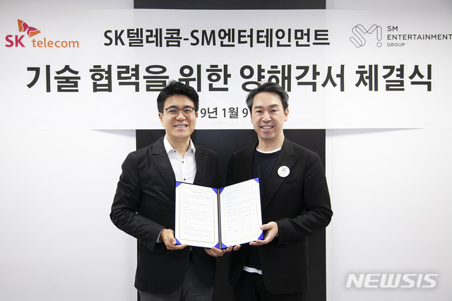 【서울=뉴시스】 9일(현지시각) 미국 라스베이거스 컨벤션센터에서 열린 체결식에 참석한 SK텔레콤 박진효 ICT기술센터장(왼쪽)과 SM엔터테인먼트그룹 김영민 총괄사장. (사진/SK텔레콤 제공) photo@newsis.com