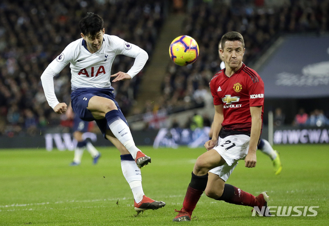 Tottenham's Son Heung-Min has a shot blocked by Manchester United's Ander Herrera, right, during the English Premier League soccer match between Tottenham Hotspur and Manchester United at Wembley stadium in London, England, Sunday, Jan. 13, 2019. (AP Photo/Tim Ireland)
