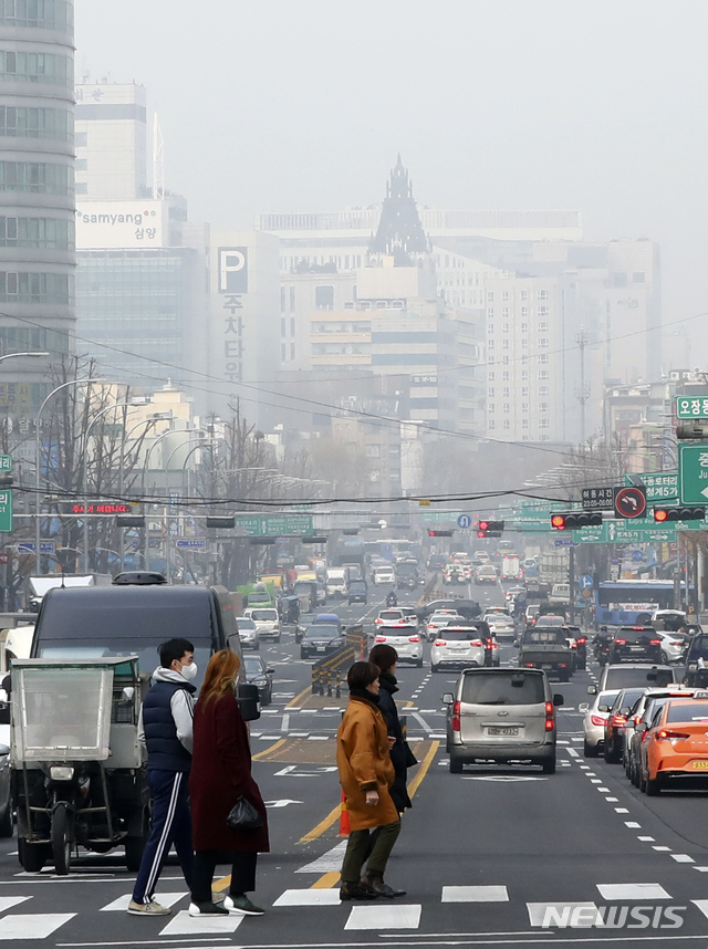 【서울=뉴시스】최진석 기자 = 최악의 미세먼지로 서울을 비롯한 수도권에 미세먼지 비상저감조치가 내려진 14일 오후 서울 도심에서 시민이 마스크를 쓴 채 발걸음을 재촉하고 있다. 기승을 부리는 최악의 미세먼지는 쉽게 수그러들지 않고 내일 오전까지 이어지다 오후부터 찬바람이 불어오면서 차츰 해소될 전망이다. 2019.01.14.myjs@newsis.com