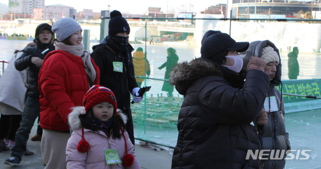 【화천=뉴시스】한윤식 기자 = 아침 기온이 영하 12도 이하로 뚝 떨어진 18일 오전 동남아 관광객들이 강원 화천군 화천천 일원에서 열리는 화천산천어축제장을 찾고 있다. 2019.01.18. ysh@newsis.com