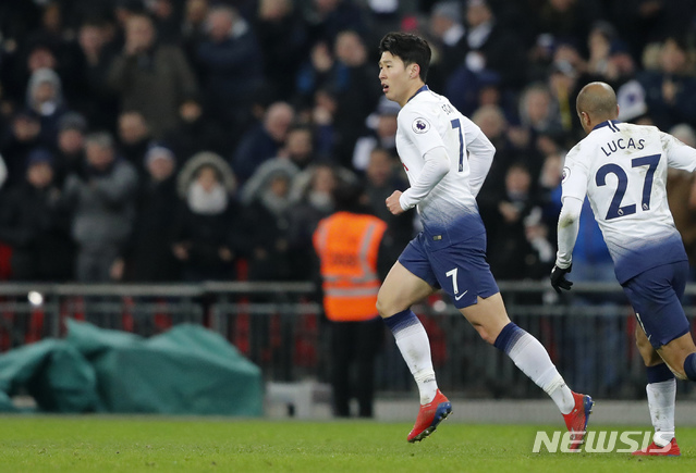 Tottenham's Son Heung-Min, left, celebrates after scoring his side's opening goal during the English Premier League soccer match between Tottenham Hotspur and Watford at Wembley Stadium in London, Wednesday, Jan. 30, 2019.(AP Photo/Frank Augstein)