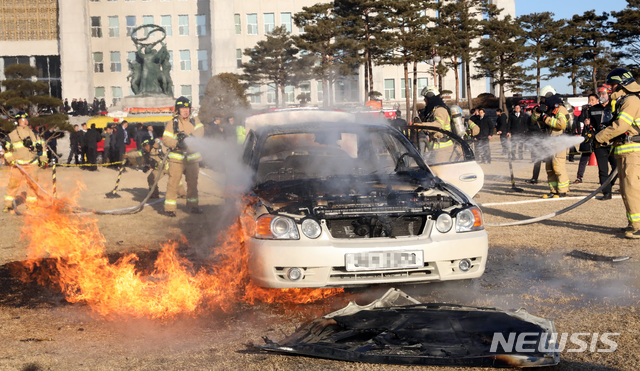 【서울=뉴시스】박영태 기자 = 1일 오전 서울 영등포구 여의도 국회 잔디마당에서 한 시민이 분신을 시도, 차량에 붙은 불을 소방관들이 끄고 있다. 이 시민은 분신을 시도하며 뿌린 전단지에서 국회의원 특수활동비 입법활동비 등 수많은 특권 폐지를 주장했다. 2019.02.01.since1999@newsis.com