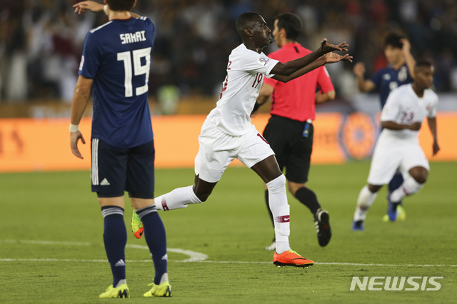 Qatar's forward Almoez Ali , center, celebrates after he scored first goal during the AFC Asian Cup final match between Japan and Qatar in Zayed Sport City in Abu Dhabi, United Arab Emirates, Friday, Feb. 1, 2019. (AP Photo/Kamran Jebreili)
