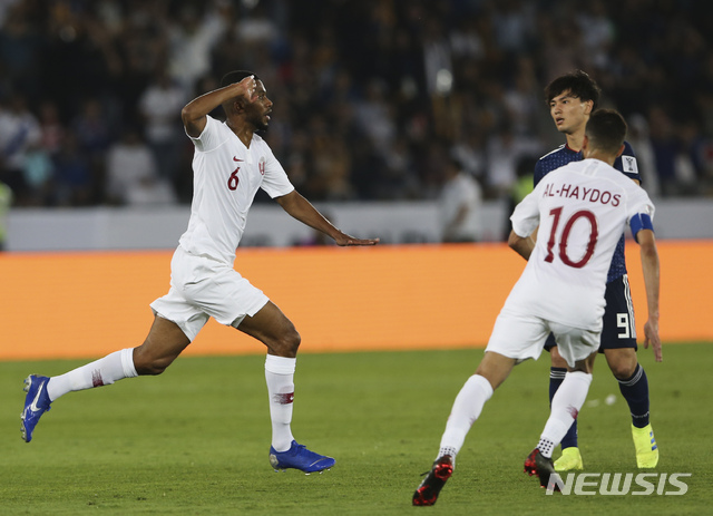 Qatar's midfielder Abdelaziz Hatem, left, celebrates after he scored his team's second goal during the AFC Asian Cup final match between Japan and Qatar in Zayed Sport City in Abu Dhabi, United Arab Emirates, Friday, Feb. 1, 2019. (AP Photo/Kamran Jebreili)