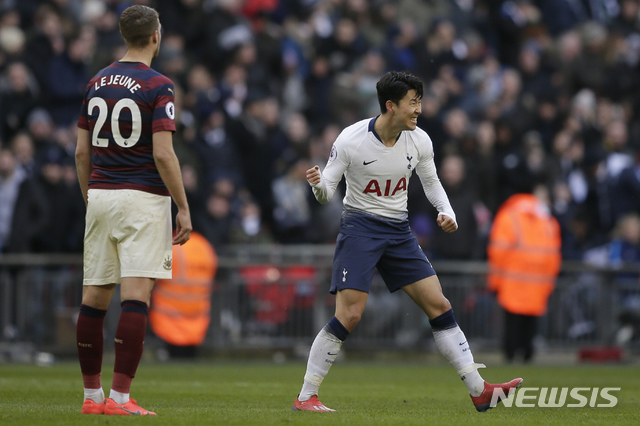 Tottenham's Son Heung-min, right, celebrates after scoring his side's opening goal during the English Premier League soccer match between Tottenham Hotspur and Newcastle at Wembley Stadium in London, Saturday, Feb. 2, 2019. (AP Photo/Tim Ireland)