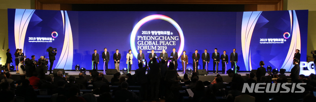 【평창=뉴시스】김경목 기자 = 문희상 국회의장(왼쪽부터 여섯 번째), 레흐 바웬사 폴란드 전 대통령(일곱 번째), 조명균 통일부 장관(여덟 번째), 진선미 여성가족부 장관(네 번째), 조현 외교부 1차관(두 번째), 최문순 강원도지사(오른쪽에서 첫 번째), 한왕기 평창군수(오른쪽에서 두 번째), 한금석 강원도의회 의장(왼쪽에서 첫 번째) 등이 9일 오후 강원 평창군 평창알펜시아리조트 컨벤션센터 대연회장에서 열린 2019 평창평화포럼 개회식에서 평화 세리머니인 사인 세리머니에 앞서 기념사진을 촬영하고 있다. 2019.02.09. photo31@newsis.com