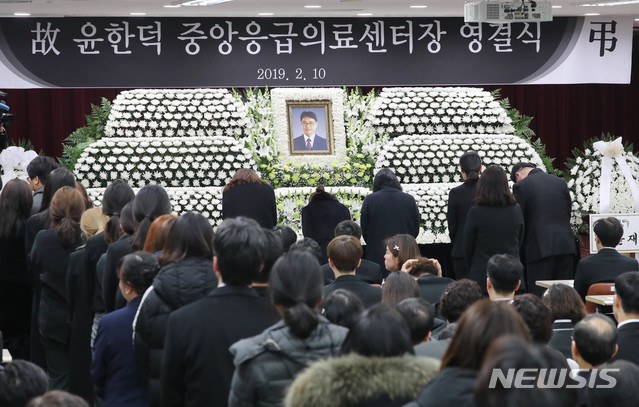 【서울=뉴시스】박미소 수습기자 =설 연휴 근무 중 돌연 사망한 국립중앙의료원 윤한덕 중앙응급의료센터장의 영결식이 엄수된 10일 오전 서울 국립중앙의료원에서 고인의 동료가 헌화하고 있다. 2019.02.10. photo@newsis.com