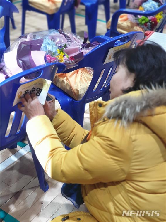 【안산=뉴시스】 이승호 기자 = 12일 오전 경기 안산 단원고에서 세월호 희생학생 명예 졸업식이 끝난 뒤 한 유족이 자녀의 이름 표를 조심스럽게 떼고 있다.2019.02.12. jayoo2000@newsis.com
