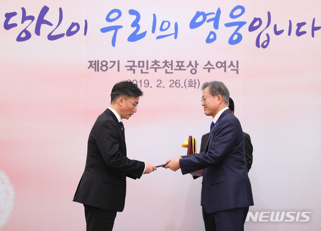 【서울=뉴시스】전신 기자 = 문재인 대통령이 26일 청와대 본관에서 열린 제8기 국민추천포상 수여식에서 이국종 교수(아주대병원 권역외상센터소장)에게 국민훈장 무궁화장을 수여하고 있다. 2019.02.26.&nbsp; photo1006@newsis.com