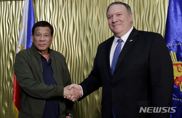 Philippine President Rodrigo Duterte, left, greets U.S. State Secretary Mike Pompeo upon arrival at Villamor Air Base in suburban Pasay city southeast of Manila, Philippines, Thursday, Feb. 28, 2019. Pompeo, who joined U.S. President Donald Trump in the second summit with North Korean leader Kim Jong-un in Vietnam, is here for talks on the two countries' relations as well as the mutual defense treaty. (AP Photo/Bullit Marquez, POOL)