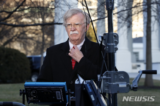 National security adviser John Bolton straightens his tie before an interview, Tuesday, March 5, 2019, at the White House in Washington. (AP Photo/Jacquelyn Martin)