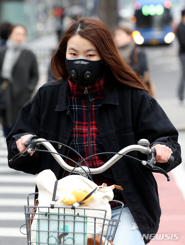 【서울=뉴시스】김병문 수습기자 = 닷새만에 초미세먼지 주의보가 발령된 12일 오후 서울 종로구 광화문네거리에서 마스크를 착용한 시민이 자전거를 타고 있다. 2019.03.12. dadazon@newsis.com