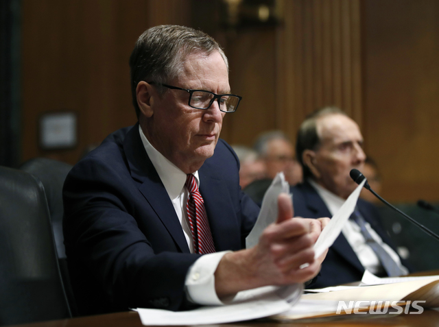 FILE - In this March 14, 2017, file photo, United States Trade Representative-nominee Robert Lighthizer, foreground, looks at documents during his confirmation hearing on Capitol Hill in Washington. Lighthizer, the top U.S. trade negotiator, suggests that the U.S. and China are nearing an agreement that would end their trade conflict, but wouldn't commit to a specific time frame. "Our hope is that we are in the final weeks of having an agreement," U.S. Trade Representative Lighthizer told the Senate Finance Committee. (AP Photo/Manuel Balce Ceneta, File)