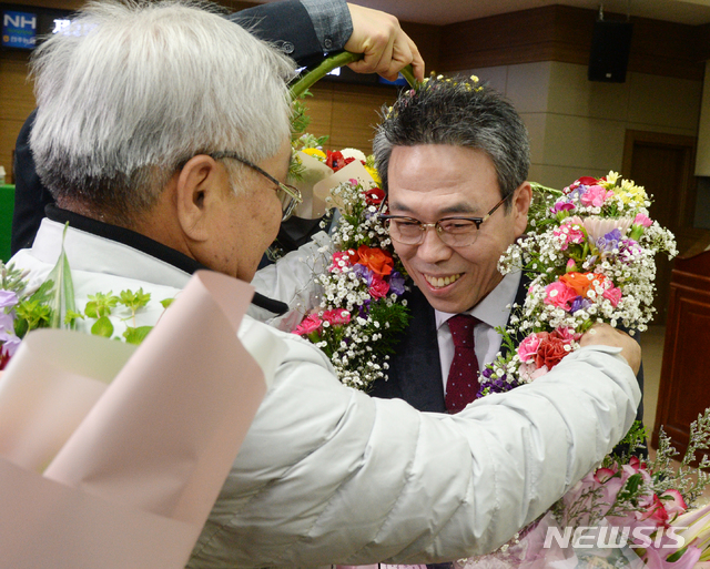 【전주=뉴시스】 김얼 기자= 제2회 전국동시조합장 선거 날인 13일 전북 전주시 전주농협 4층 회의실 개표소에서 전주농협 임인규 당선인이 지지자들에게 꽃다발을 선물받고 있다. 2019.03.13.  pmkeul@newsis.com