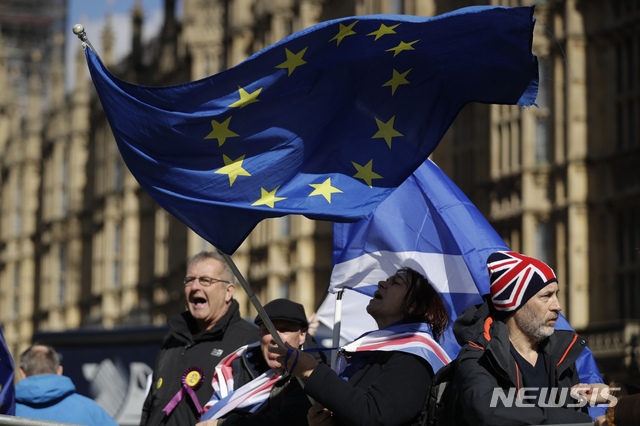 Anti-Brexit remain in the European Union supporters shout slogans during a protest outside the Houses of Parliament in London, Thursday, March 14, 2019. British lawmakers faced another tumultuous day Thursday, as Parliament prepared to vote on whether to request a delay to the country's scheduled departure from the European Union and Prime Minister Theresa May struggled to shore up her shattered authority. (AP Photo/Matt Dunham)