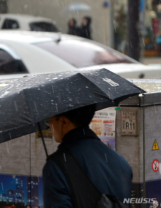 【청주=뉴시스】인진연 기자 = 15일 오후 충북 청주지역에 천둥·번개를 동반한 우박이 쏟아저 시민이 우산을 쓰고 걷고 있다.&nbsp; 청주기상지청은 충청내륙과 서해상의 구름대내에서 강한 불안정으로 인해 비 구름대가 상공 10km 이상까지 매우 발달해 시설물 관리에 주의할 것을 당부했다. 2019.03.15inphoto@newsis.com