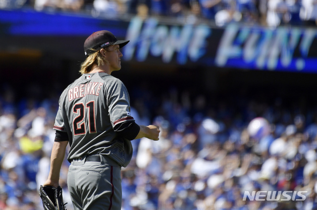 Arizona Diamondbacks starting pitcher Zack Greinke walks back to the mound after giving up a home run to Los Angeles Dodgers' Austin Barnes during the fourth inning of a baseball game Thursday, March 28, 2019, in Los Angeles. (AP Photo/Mark J. Terrill)