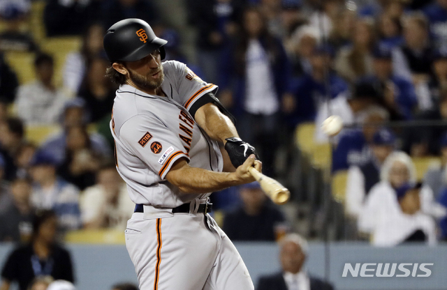 San Francisco Giants' Madison Bumgarner hits a two-run home run against the Los Angeles Dodgers during the sixth inning of a baseball game, Tuesday, April 2, 2019, in Los Angeles. (AP Photo/Marcio Jose Sanchez)