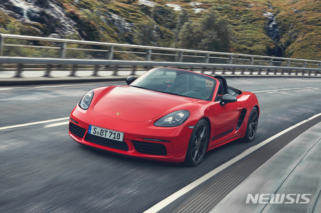 This undated photo provided by Porsche shows the 2019 Porsche 718 Boxster, one of the best sports cars on sale today. The mid-engine design gives it balanced handling around corners, while turbocharged four-cylinder engines provide plenty of thrust. (Courtesy of Porsche Cars North America via AP)