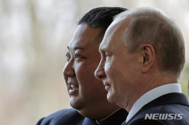 Russian President Vladimir Putin, right, and North Korea's leader Kim Jong Un pose for photographers during their meeting in Vladivostok, Russia, Thursday, April 25, 2019. Putin and Kim are set to have one-on-one meeting at the Far Eastern State University on the Russky Island across a bridge from Vladivostok. The meeting will be followed by broader talks involving officials from both sides. (AP Photo/Alexander Zemlianichenko, Pool)