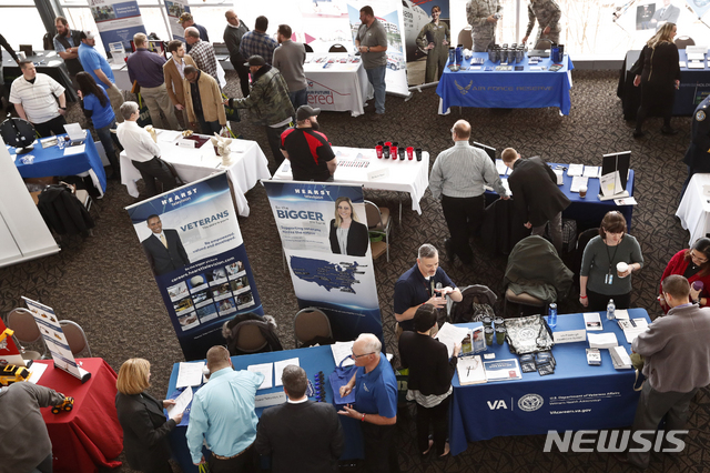 FILE - In this March 7, 2019, photo visitors to the Pittsburgh veterans job fair meet with recruiters at Heinz Field in Pittsburgh. On Friday, May 3, the U.S. government issues the April jobs report. (AP Photo/Keith Srakocic, File)