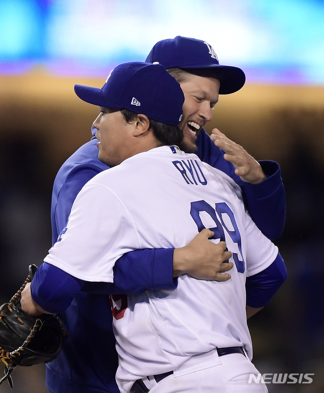 Los Angeles Dodgers' Clayton Kershaw, rear, congratulates starting pitcher Hyun-Jin Ryu, of South Korea, after Ryu threw a four-hitter against the Atlanta Braves during a baseball game Tuesday, May 7, 2019, in Los Angeles. The Dodgers won 9-0. (AP Photo/Mark J. Terrill)