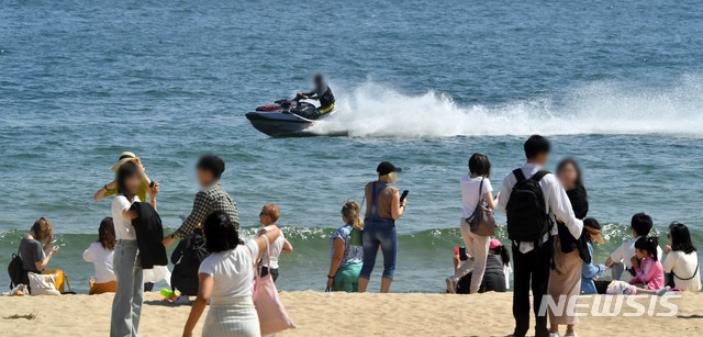 【부산=뉴시스】 하경민 기자 = 지난 12일 오후 부산 해운대해수욕장을 찾은 시민과 관광객들이 나들이를 즐기고 있는 가운데 해운대 앞 바다에 수상오토바이가 질주하고 있다. 2019.05.12. yulnetphoto@newsis.com