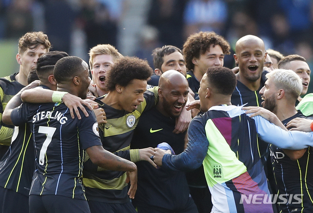 Manchester City players celebrate at the end of the English Premier League soccer match between Brighton and Manchester City at the AMEX Stadium in Brighton, England, Sunday, May 12, 2019. Manchester City defeated Brighton 4-1 to win the championship. (AP Photo/Frank Augstein)