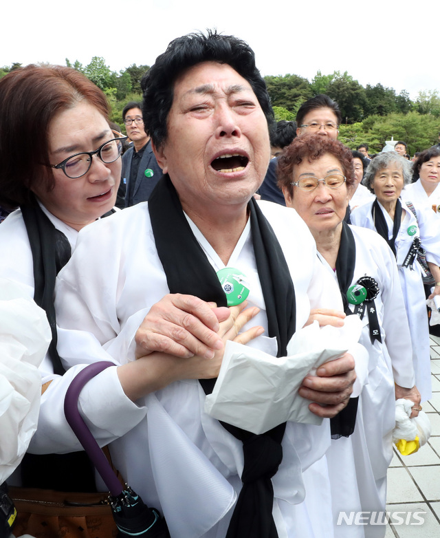 【광주=뉴시스】 박영태 기자 = 5.18민주화운동 유가족들이 18일 오전 제39주년 5.18민주화운동 기념식이 열린 광주광역시 북구 국립 5.18 민주 묘지에서 자유한국당 황교안 대표가 분향을 하려하자 안된다고 울부짖고 있다. 2019.05.18. since1999@newsis.com