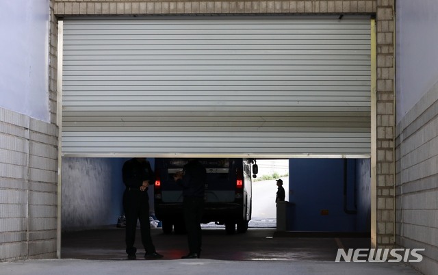【서울=뉴시스】 고범준 기자 = 31일 오전 서울 서초구 서울중앙지법에서 교도관이 호송차가 들어서자 셔터를 내리고 있다. 2019.05.31. bjko@newsis.com