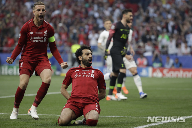 Liverpool's Mohamed Salah, bottom, celebrates after scoring his side's opening goal during the Champions League final soccer match between Tottenham Hotspur and Liverpool at the Wanda Metropolitano Stadium in Madrid, Saturday, June 1, 2019. (AP Photo/Felipe Dana)