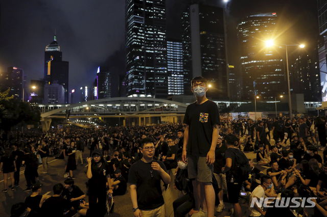 Protesters gather into the night against an unpopular extradition bill in Hong Kong on Sunday, June 16, 2019. Hong Kong citizens marched for hours Sunday in a massive protest that drew a late-in-the-day apology from the city's top leader for her handling of legislation that has stoked fears of expanding control from Beijing in this former British colony. (AP Photo/Kin Cheung)