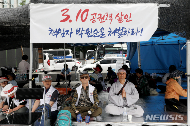 【서울=뉴시스】김병문 기자 = 우리공화당(구 대한애국당) 관계자들이 26일 오전 서울 종로구 광화문광장에서 서울시에 의해 전날 철거된 천막을 재설치 한 후 지키고 있다. 2019.06.26. dadazon@newsis.com