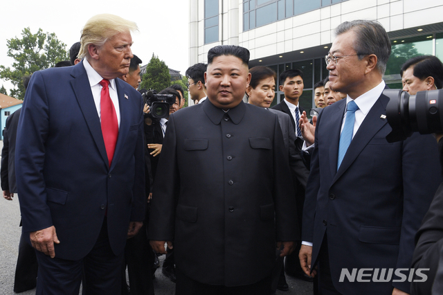 [파주=AP/뉴시스]도널드 트럼프 미국 대통령(가운데)이 지난 6월30일 경기도 파주시 비무장지대 판문점 자유의 집 앞에서 문재인 대통령(오른쪽), 김정은 북한 국무위원장(왼쪽)과 만나고 있다. 2019.12.10.